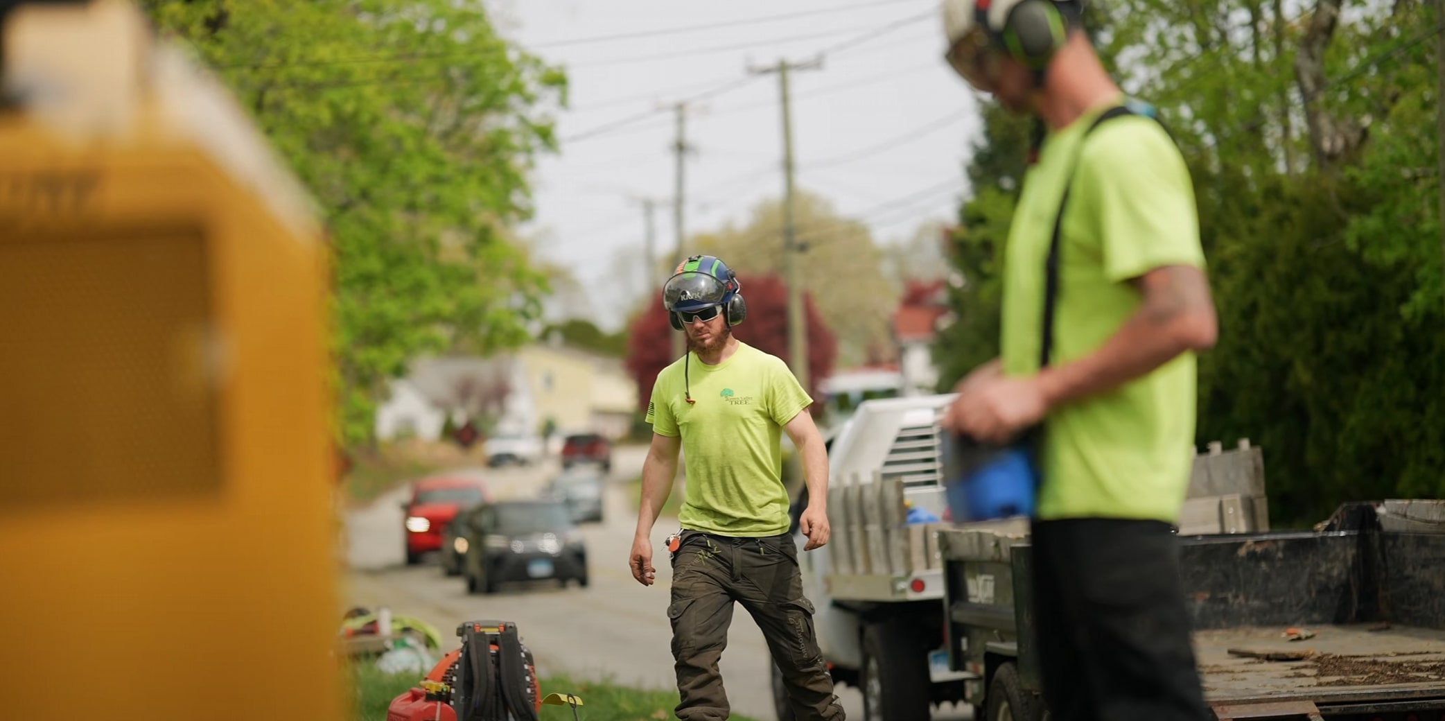 Professional tree service crew working safely on residential street